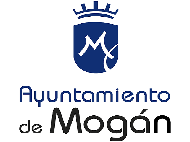 Logotipo del Ayuntamiento de Mogán que presenta un escudo azul con un diseño blanco y texto estilizado debajo.